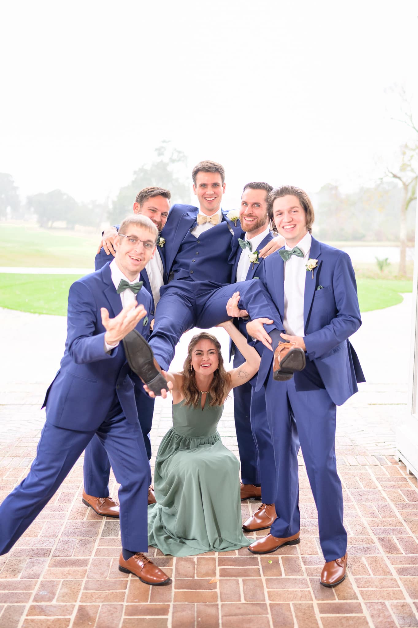 Groom with his siblings on the porch during the rain - Pawleys Plantation Golf & Country Club