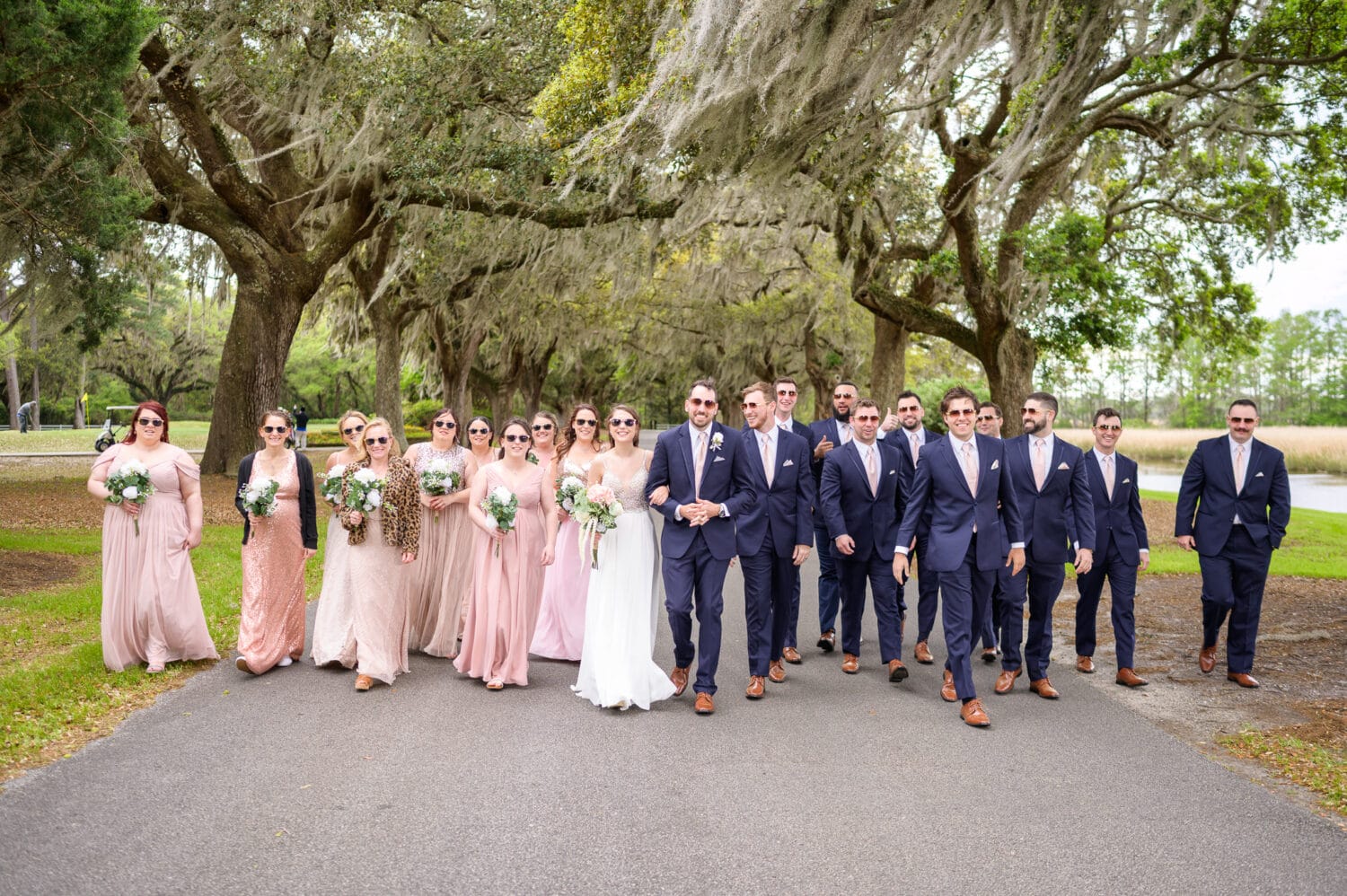 Bridal party walking together with sunglasses  - Caledonia Golf & Fish Club