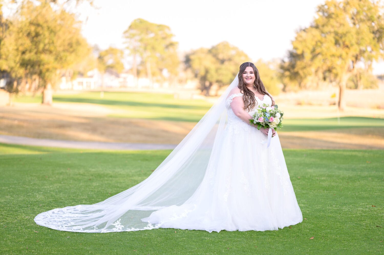 Bridal portrait with long veil in front of the golf course - Pawleys Plantation Golf & Country Club