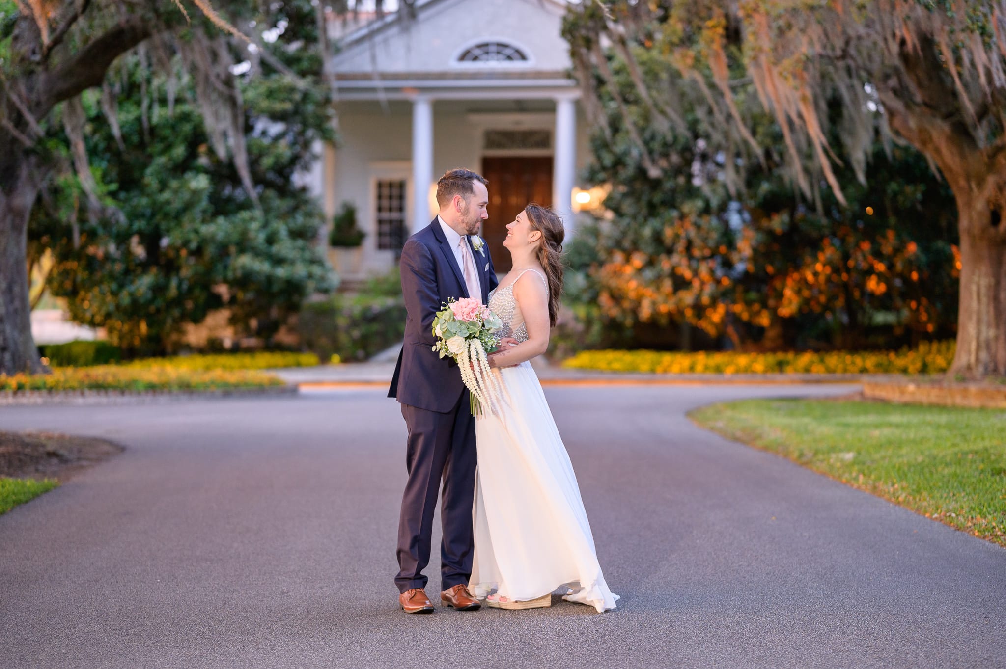 Bride and groom in front of the clubhouse - Caledonia Golf & Fish Club