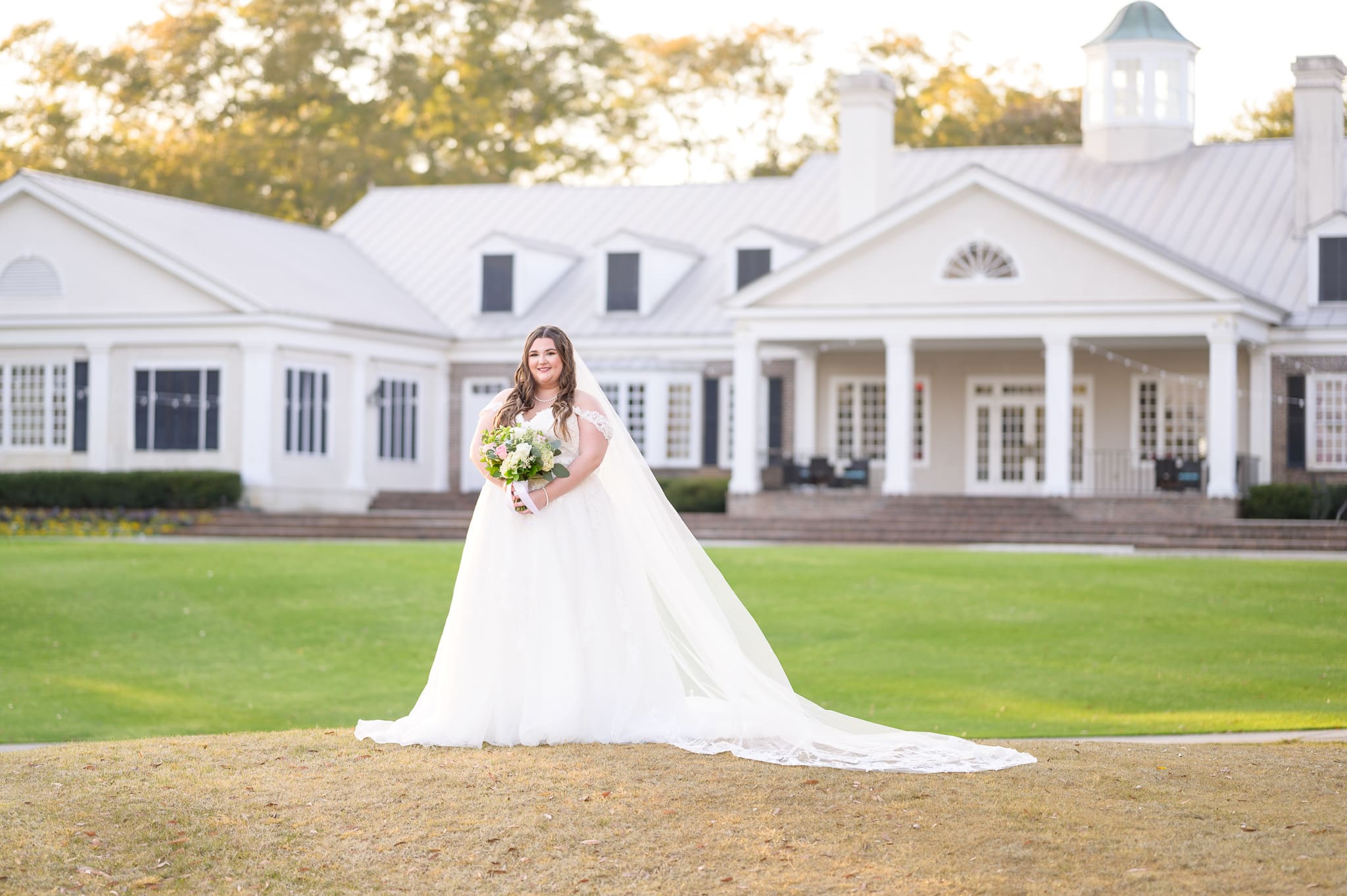 Bride holding bouquet behind the clubhouse - Pawleys Plantation Golf & Country Club