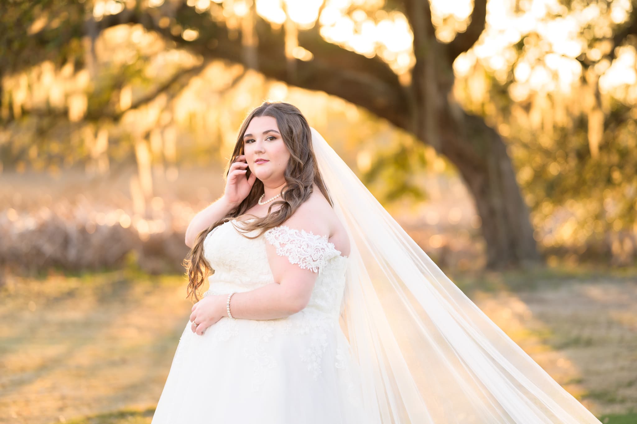 Bride touching her face in the sunset - Pawleys Plantation Golf & Country Club