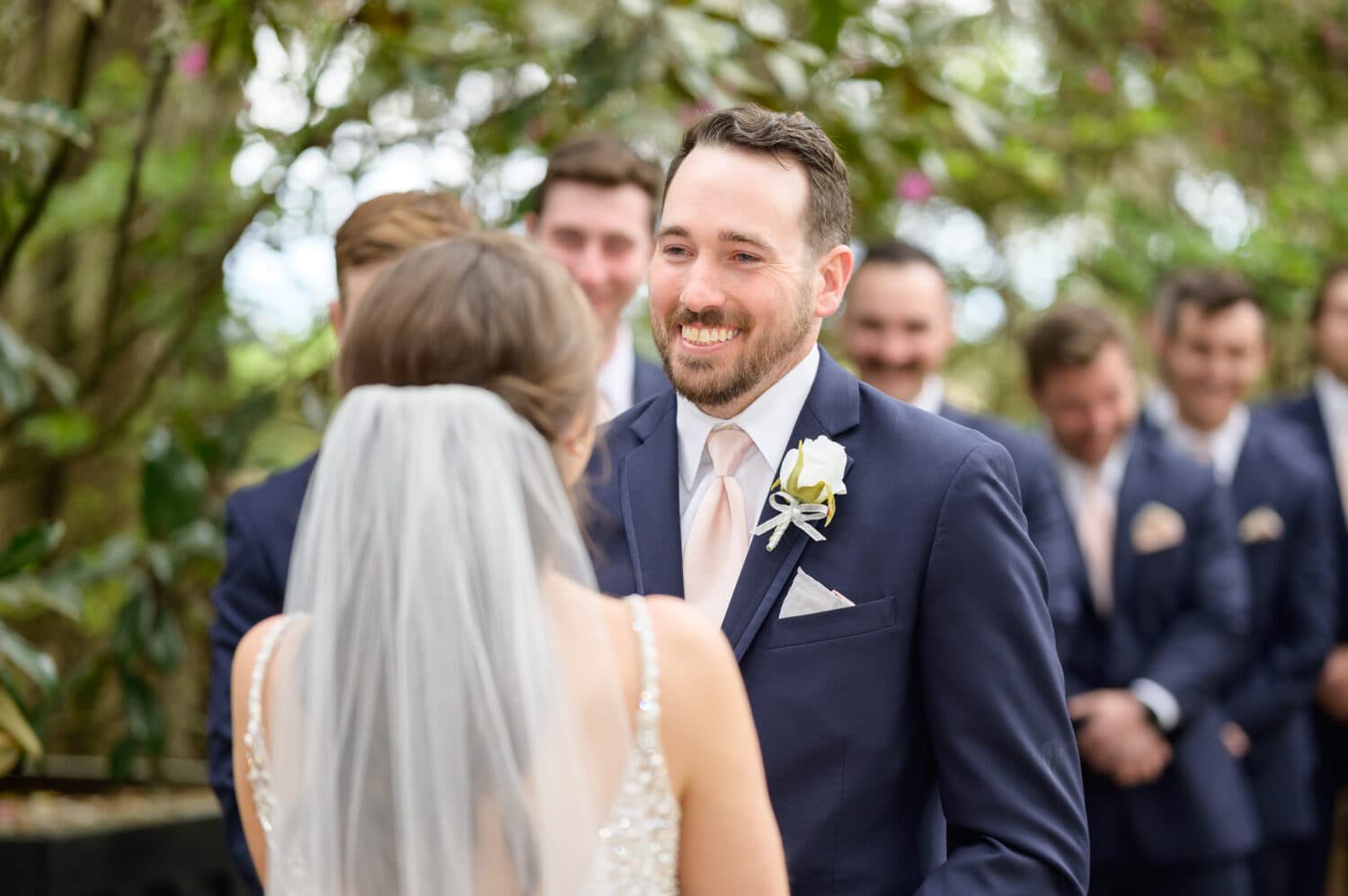 Groom smiling at bride during the ceremony - Caledonia Golf & Fish Club