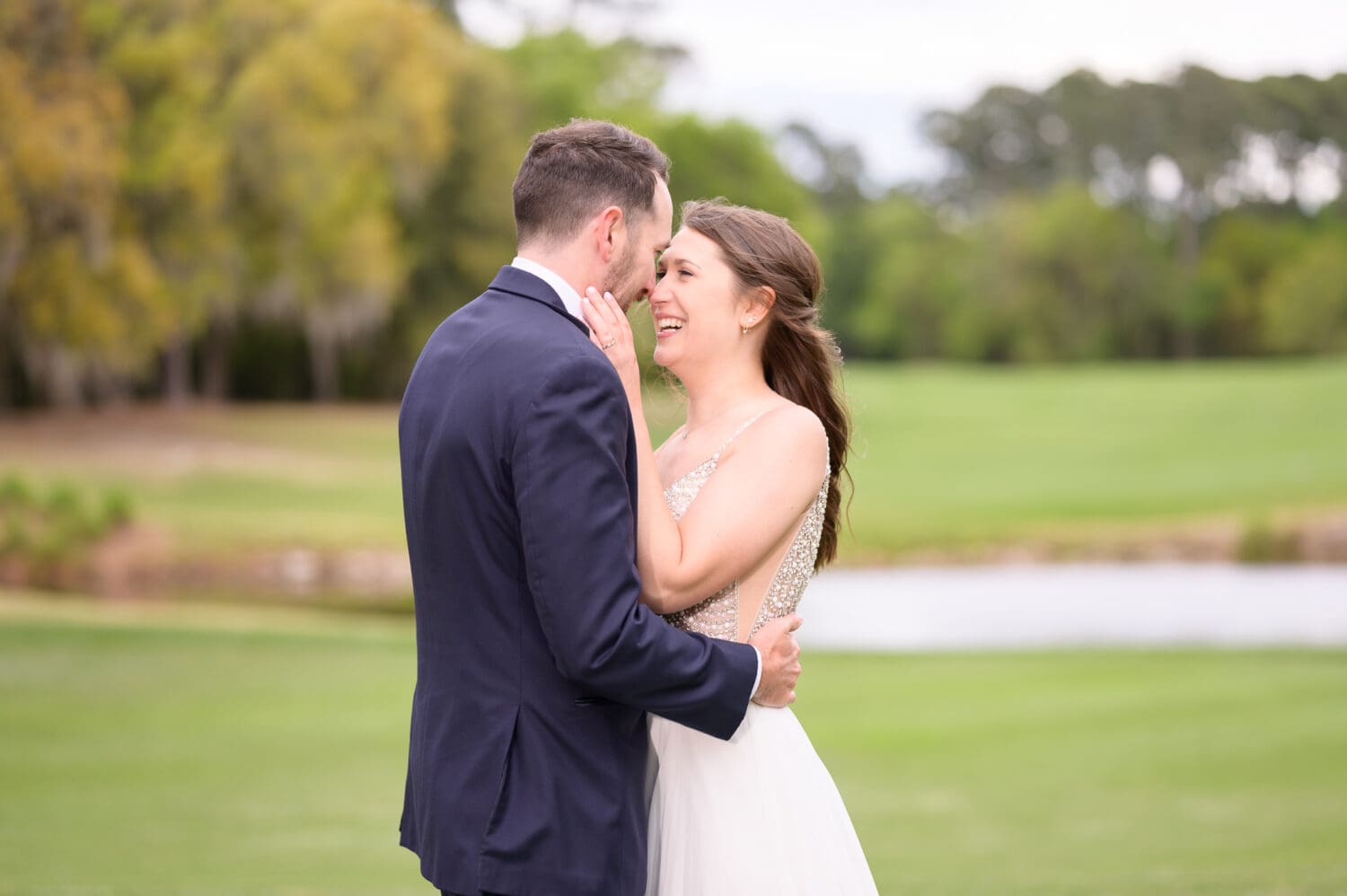Happy bride touching noses with the groom - Caledonia Golf & Fish Club