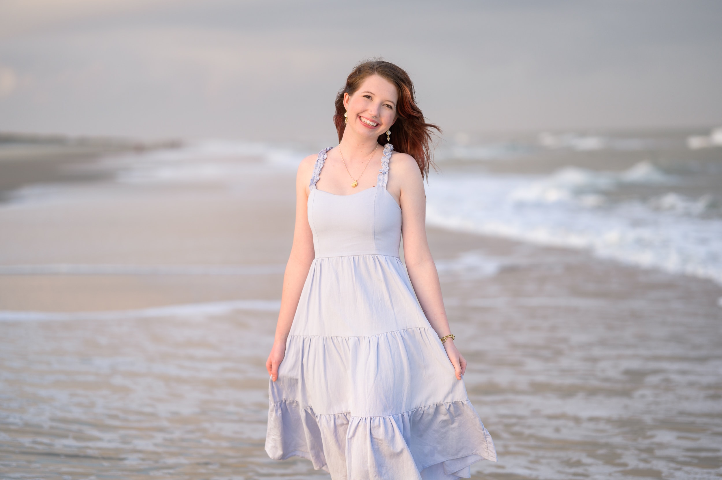 Happy girl walking down the beach holding dress - Pawleys Island