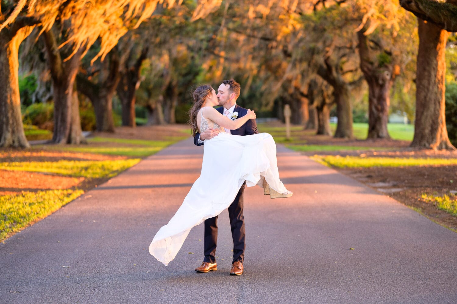 Lifting bride off the ground for a kiss - Caledonia Golf & Fish Club