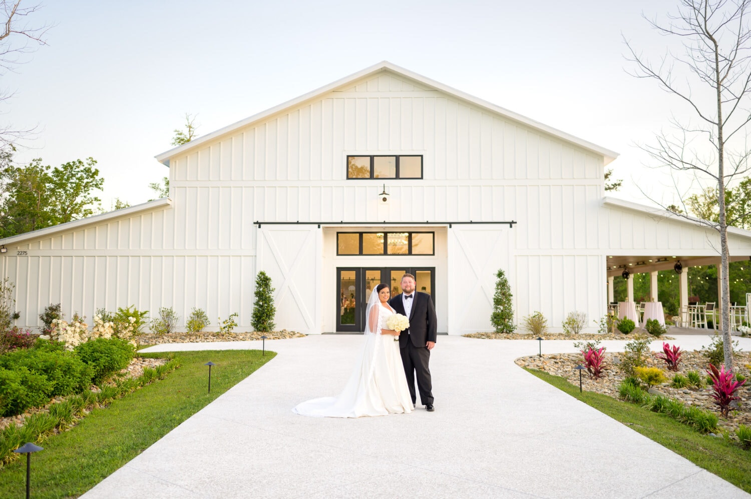 Bride and groom in front of the ballroom - The Venue at White Oaks Farm
