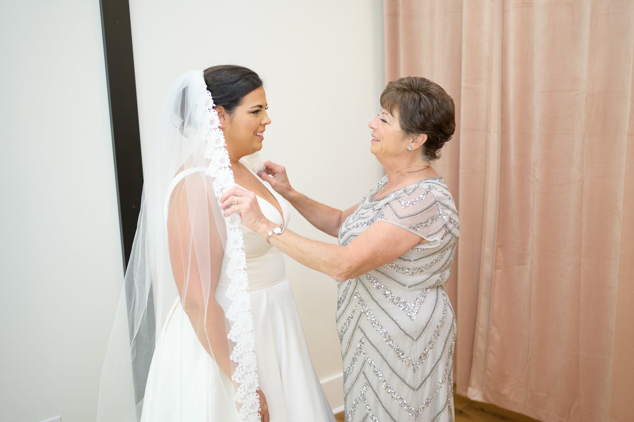 Mom helping bride with veil - The Venue at White Oaks Farm