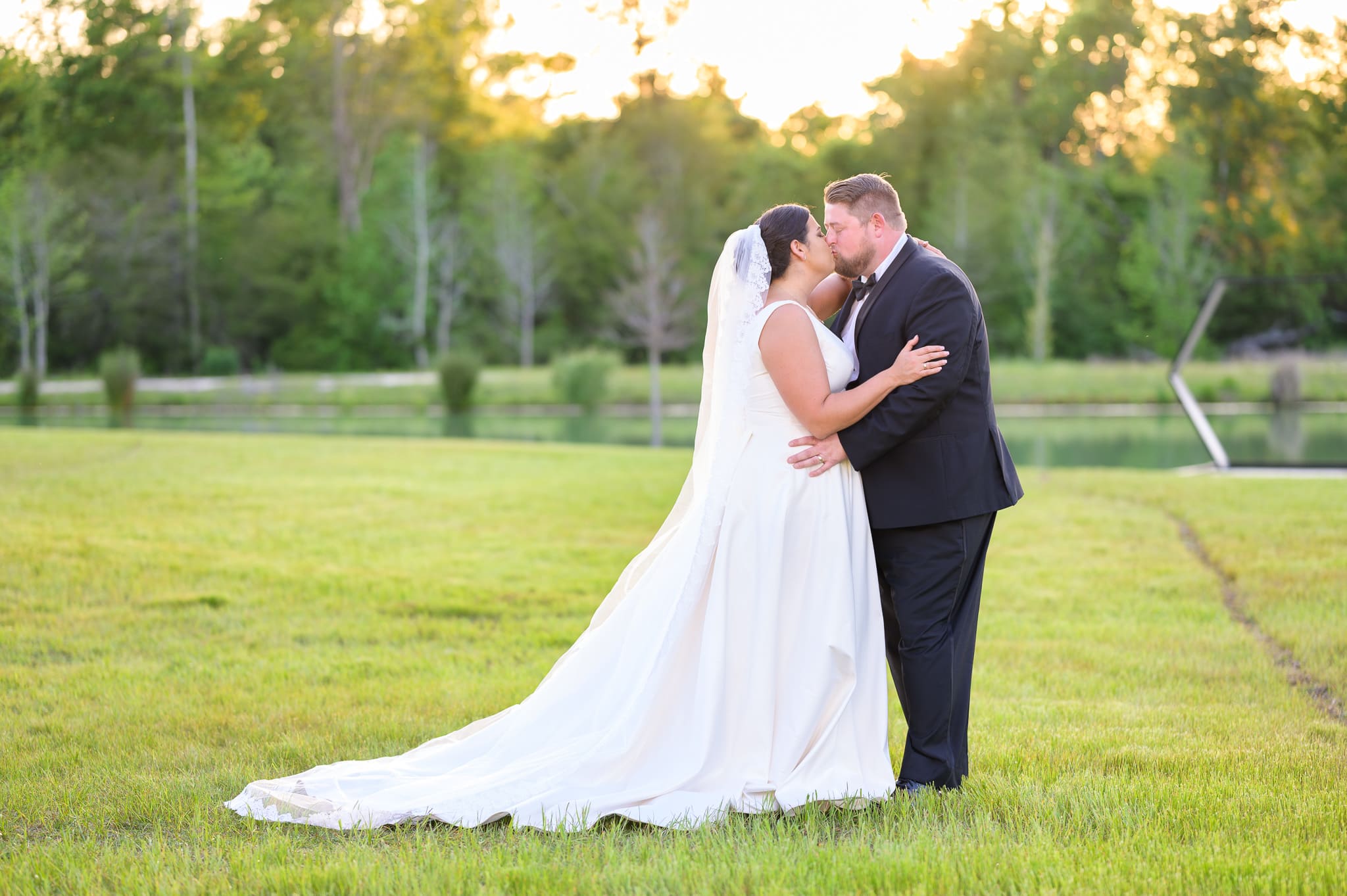 Portraits of bride and groom in the sunset by the lake - The Venue at White Oaks Farm