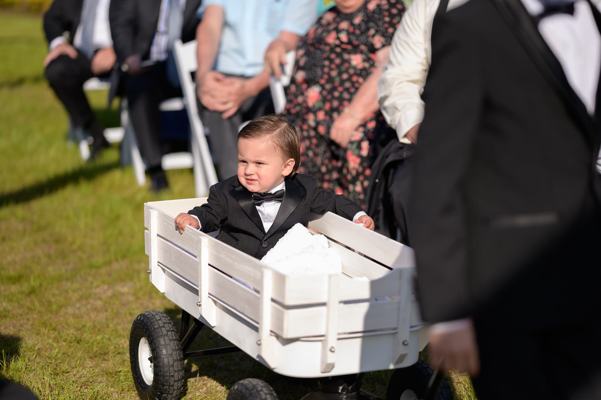 Ring-bearer riding in wagon - The Venue at White Oaks Farm