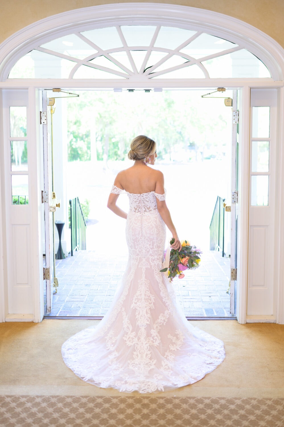 Bride stying in the light from the doorway - Pawleys Plantation Golf & Country Club