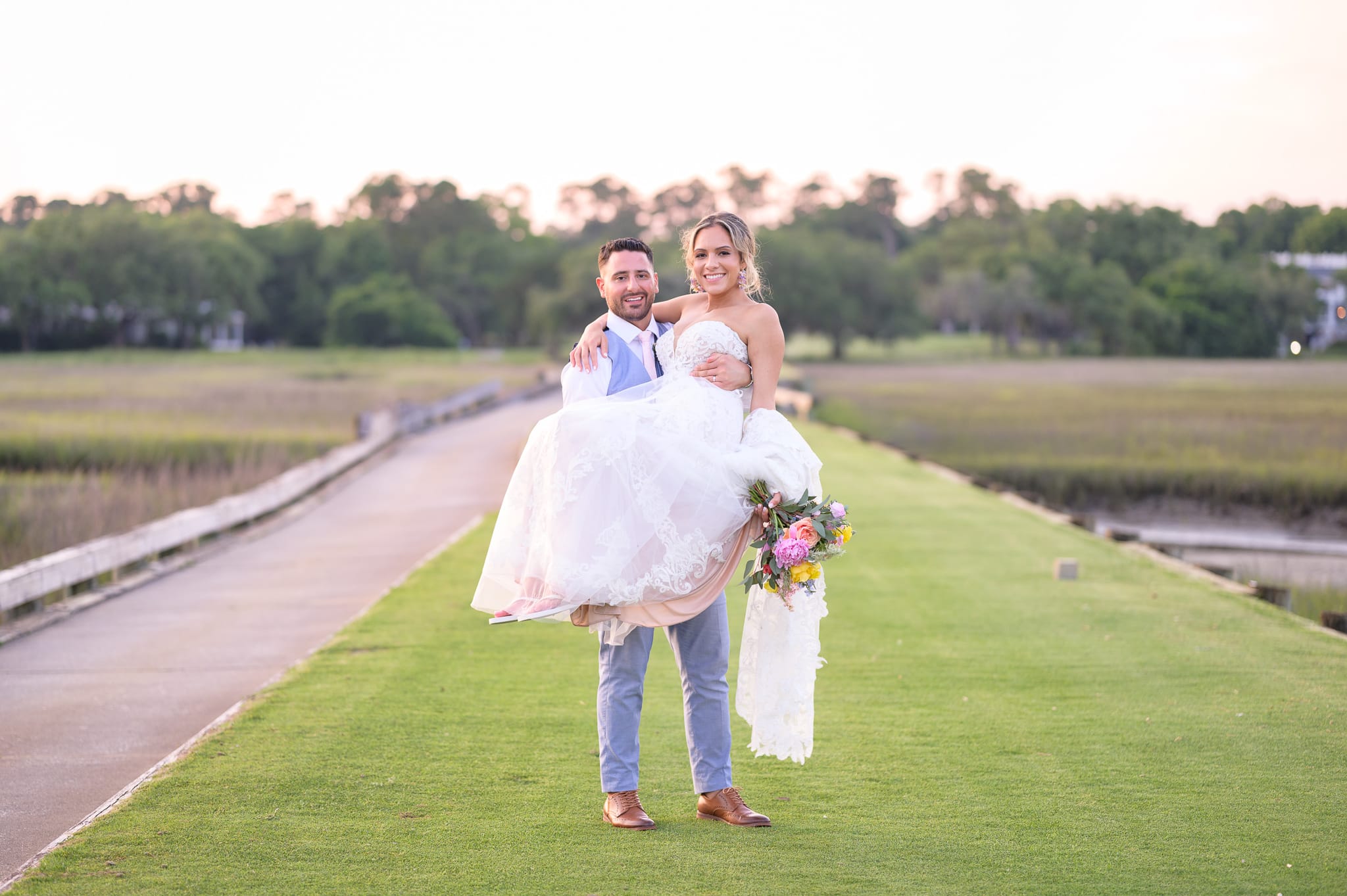 Groom carrying bride on the golf course - Pawleys Plantation Golf & Country Club