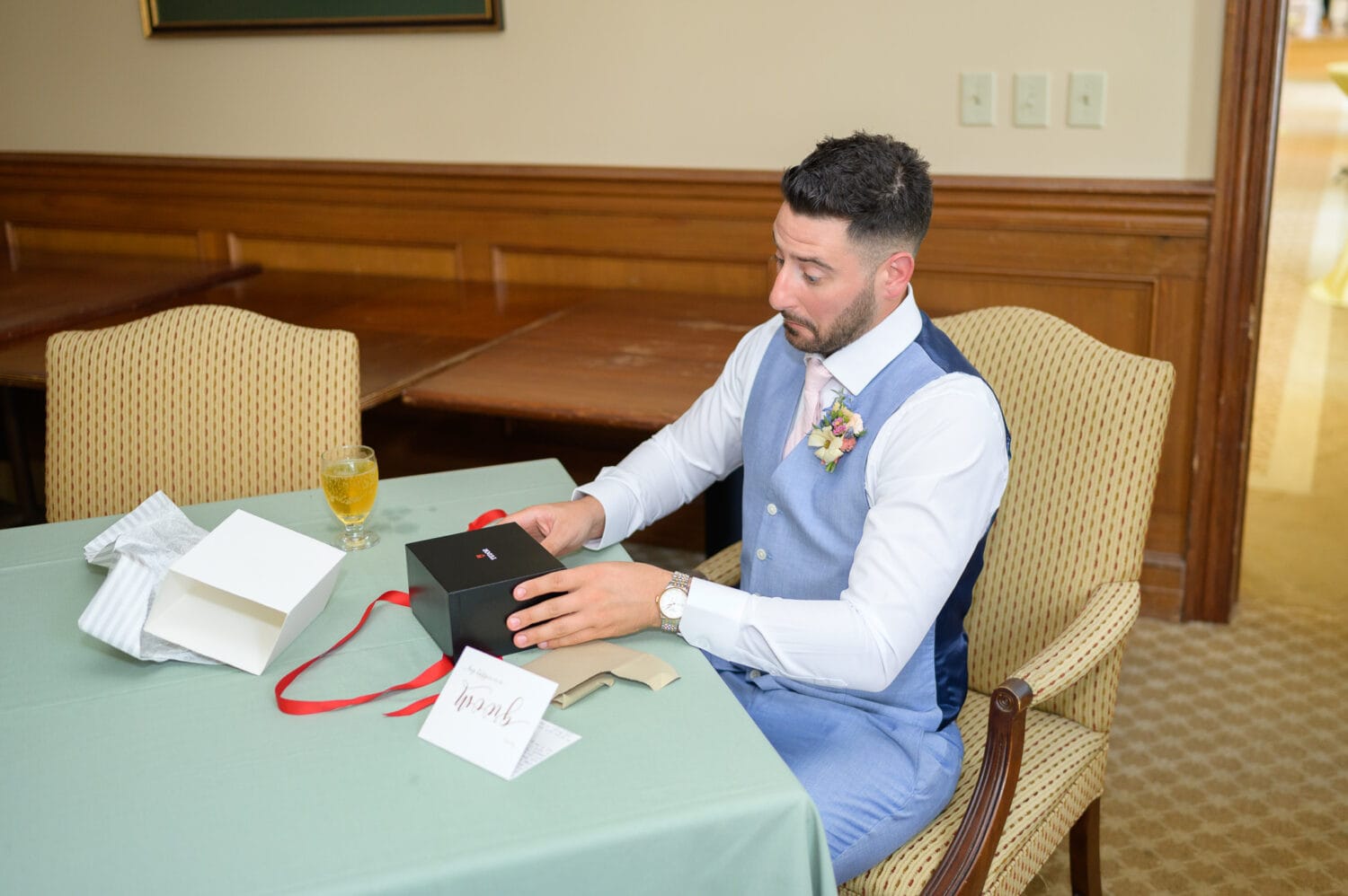 Groom opening his gift from the bride - Pawleys Plantation Golf & Country Club