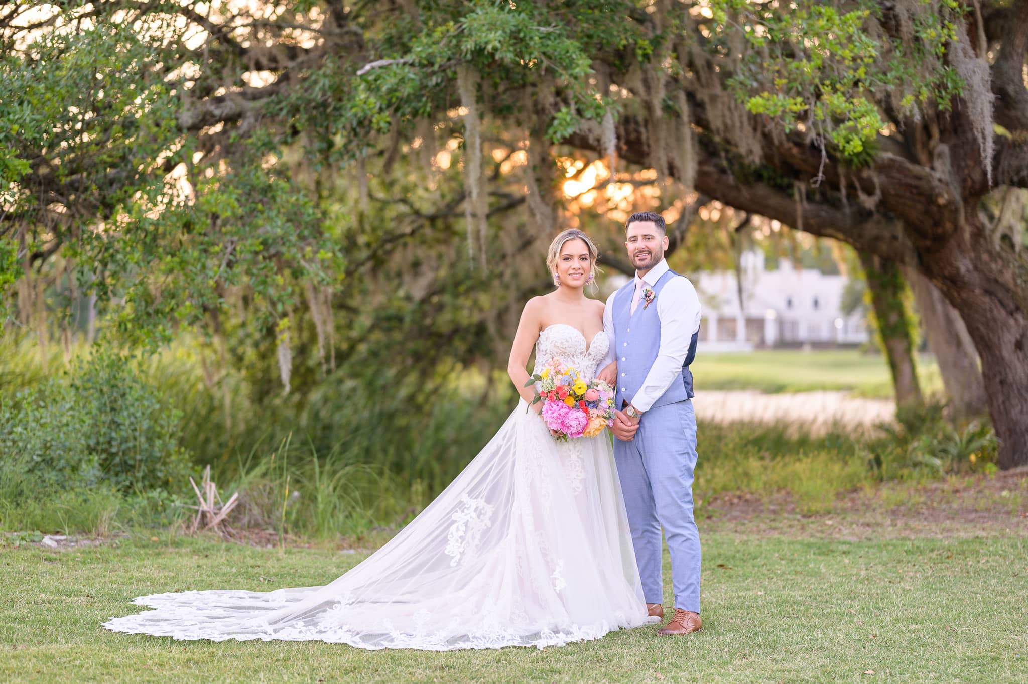 Portraits of bride and groom in front of the mossy oaks - Pawleys Plantation Golf & Country Club