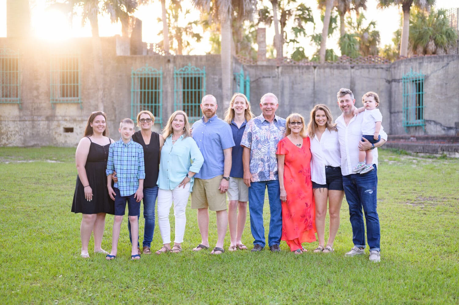 Big family group in the sunset behind the palms at the Atalaya Castle - Huntington Beach State Park