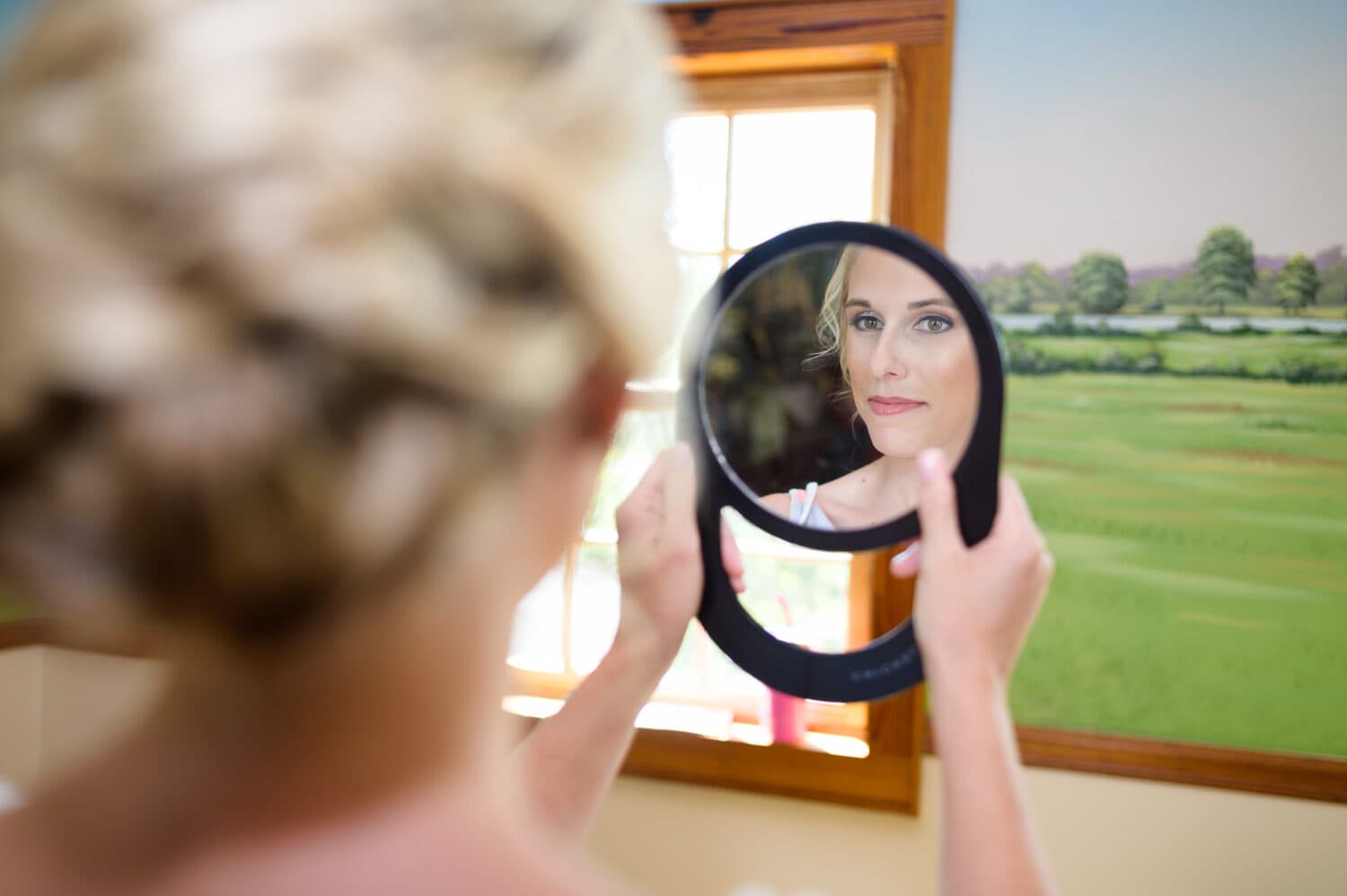 Bride checking her makeup in the mirror - Caledonia Golf & Fish Club