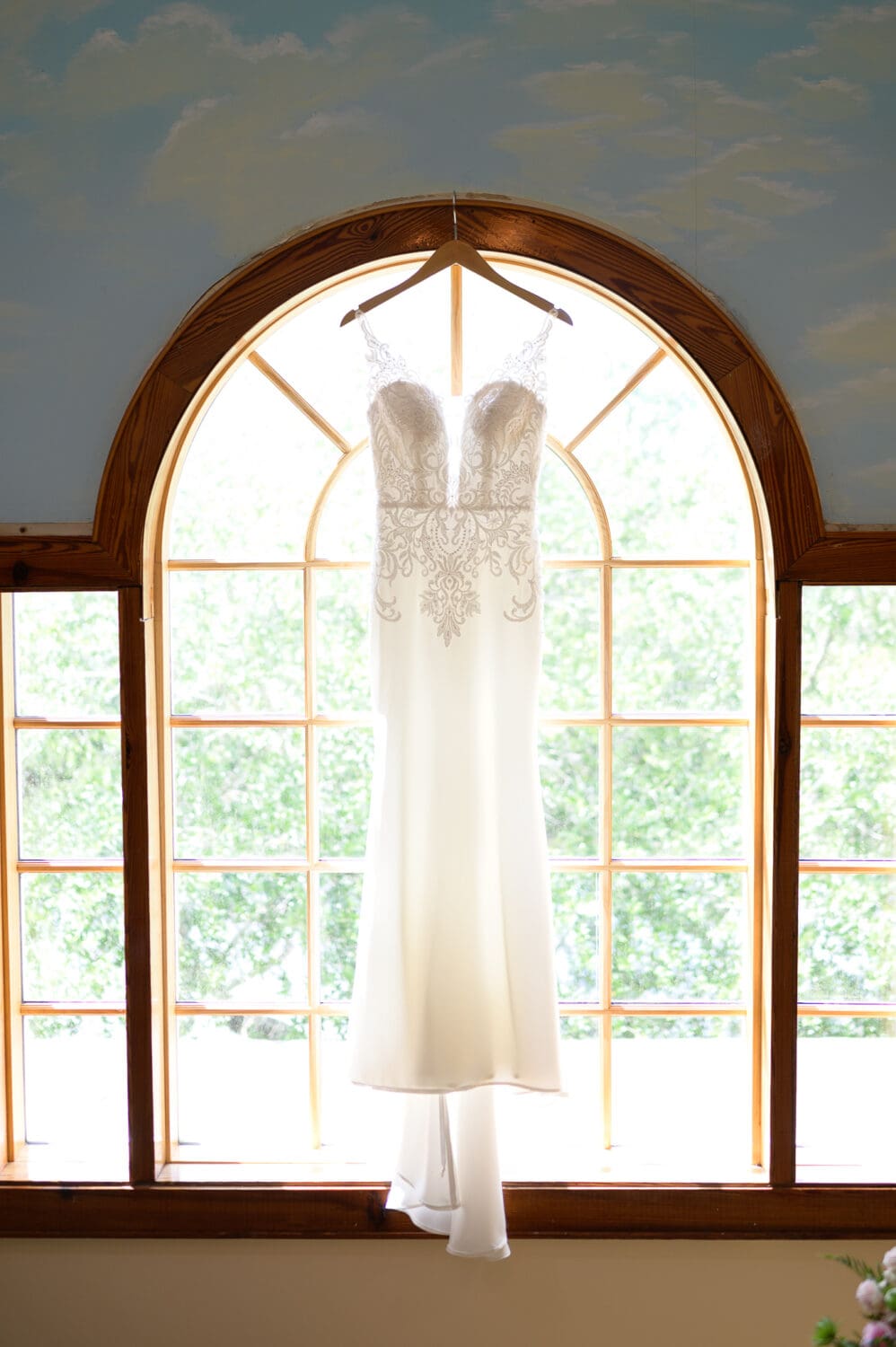 Bride's dress hanging in the window - Caledonia Golf & Fish Club