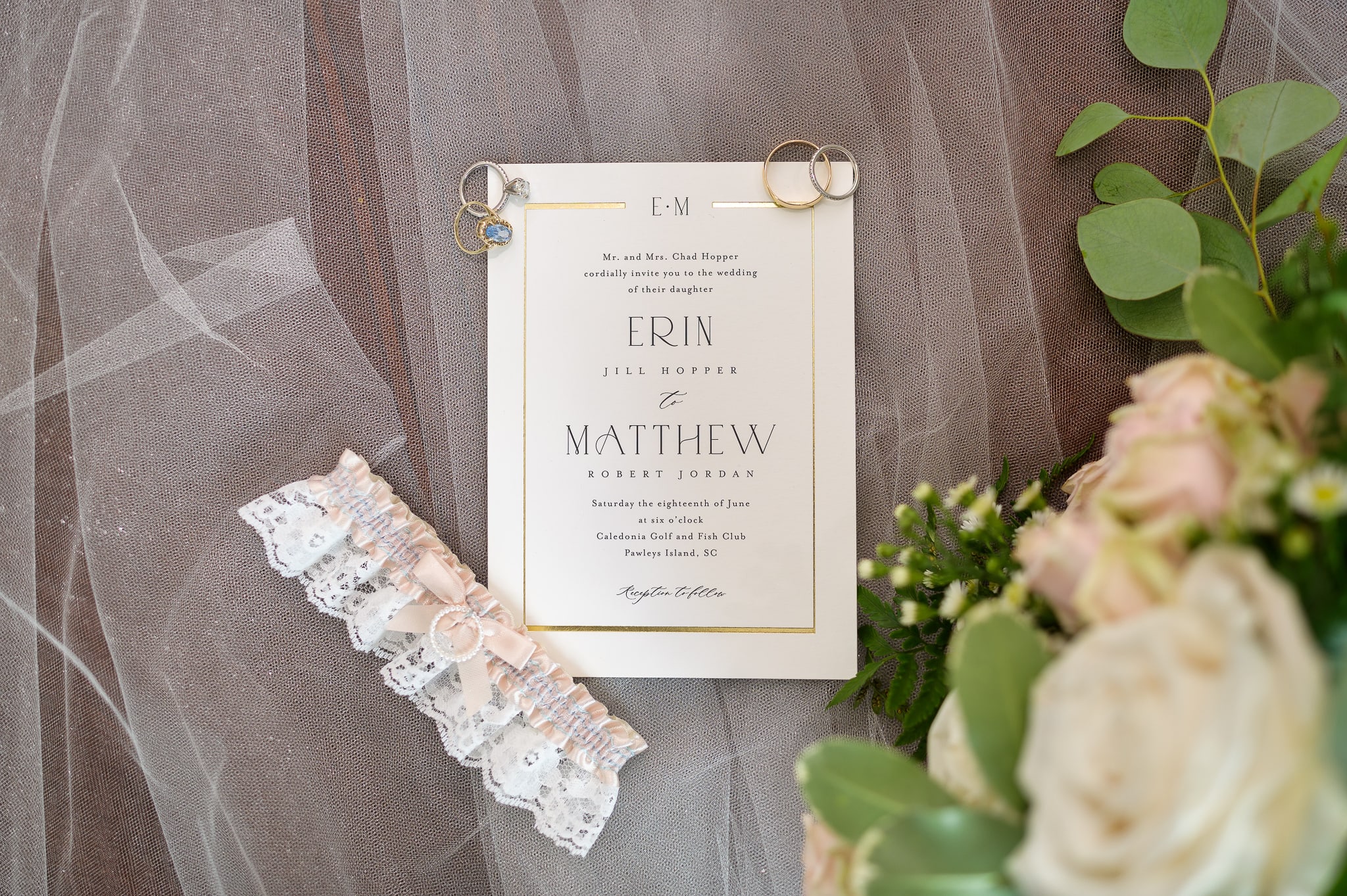 Wedding invitation laying on bride's veil - Caledonia Golf & Fish Club