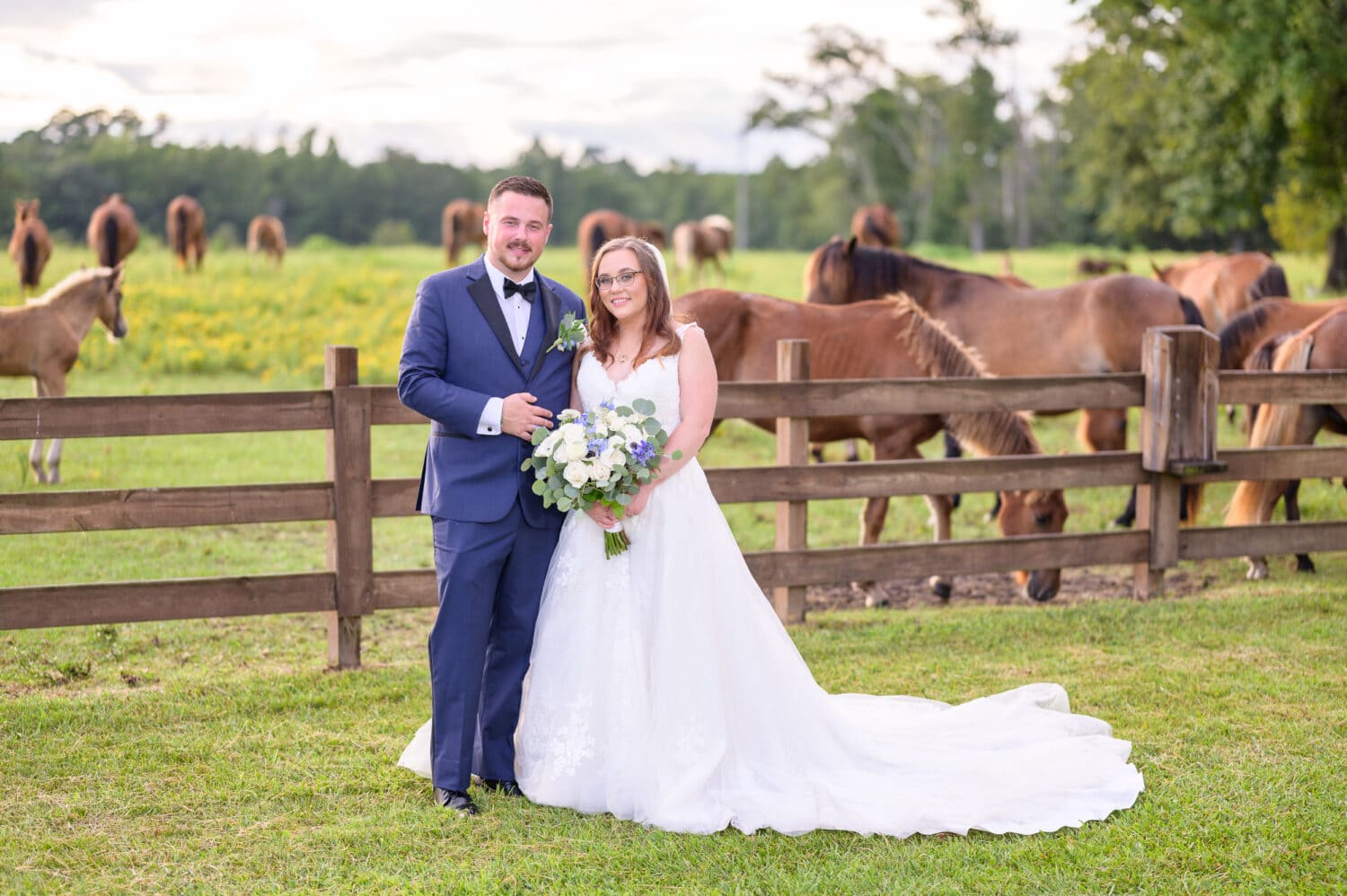 Formal portrait of bride and groom standing in front of the wild horses - Wildhorse at Parker Farms