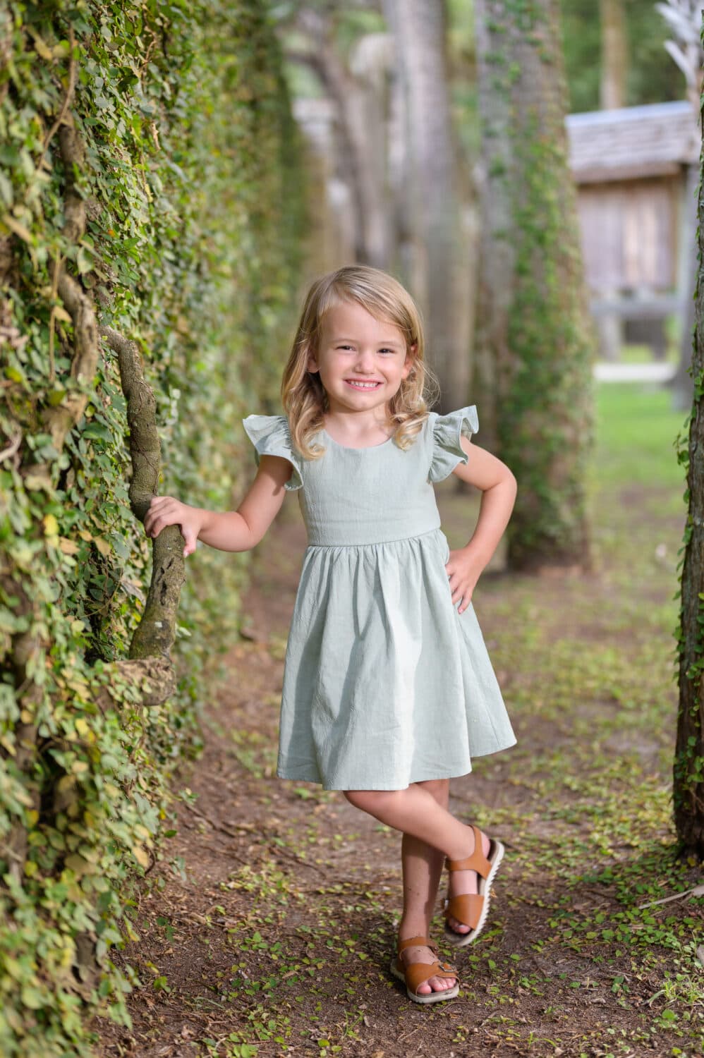 Little girl leaning against the ivy wall - Atalaya Castle - Pawleys Island