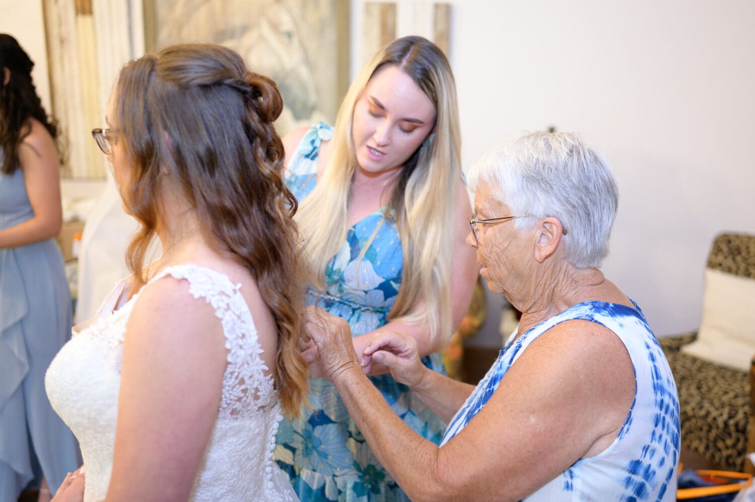 Grandmother helping bride with her dress - Wildhorse at Parker Farms