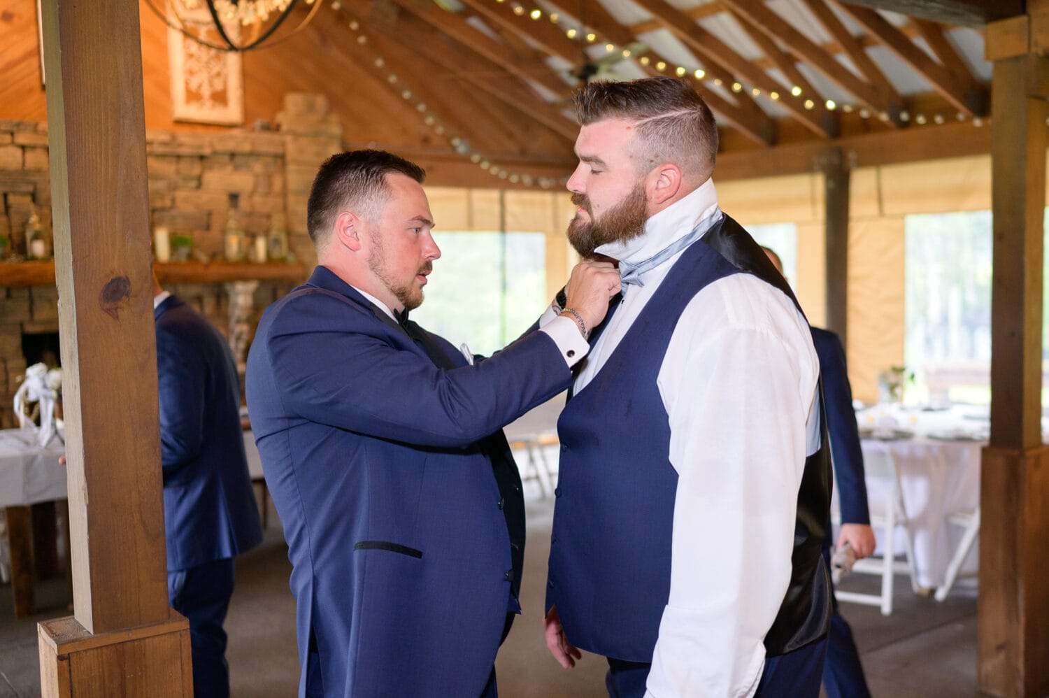 Groom helping best man with his tie - Wildhorse at Parker Farms