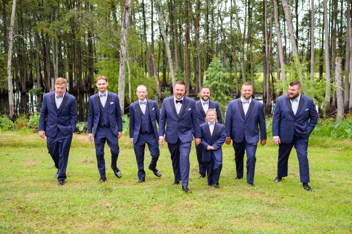Groomsmen walking together from the marsh - Wildhorse at Parker Farms
