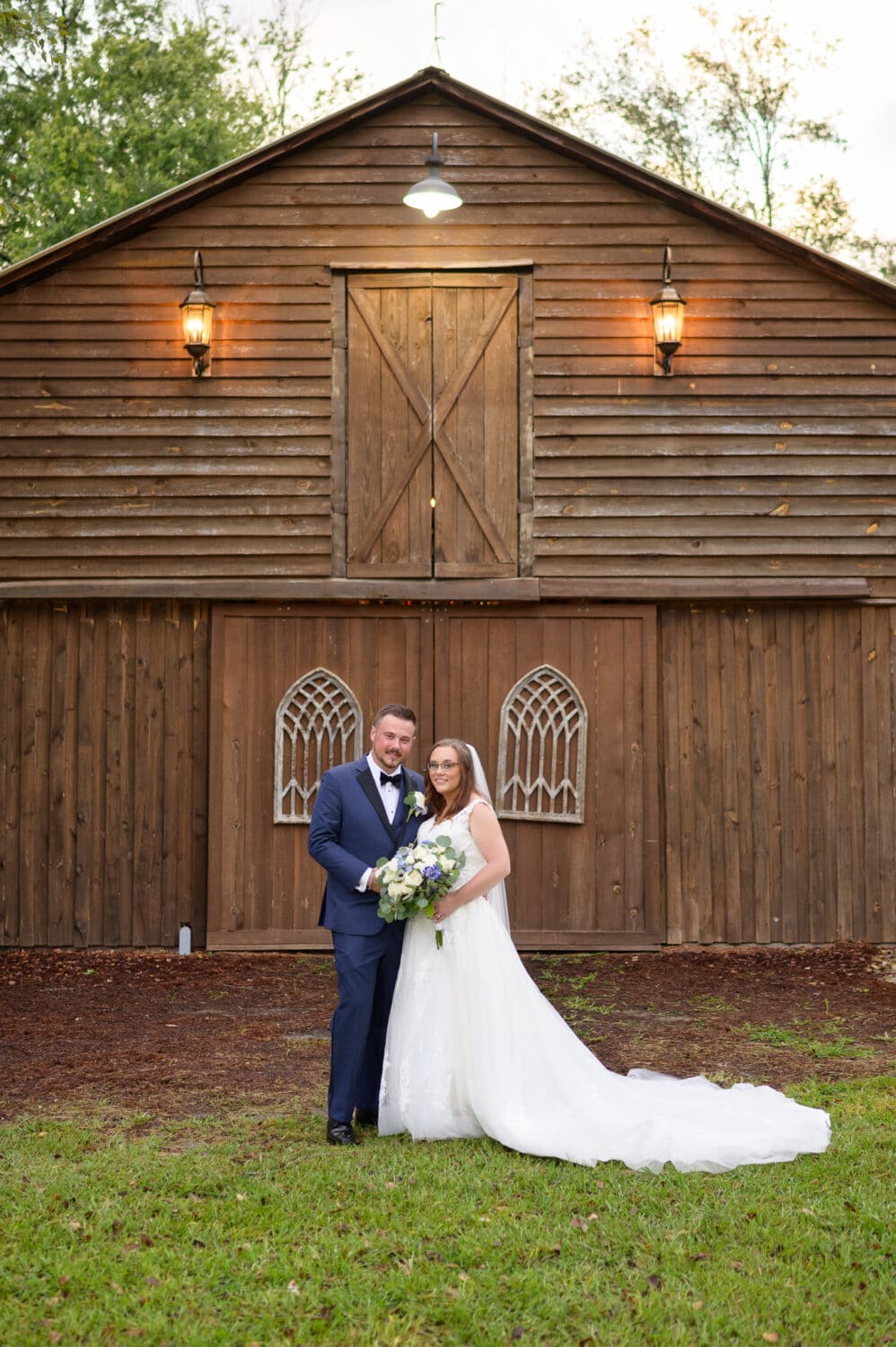 Portrait of bride and groom by the barn reception area - Wildhorse at Parker Farms