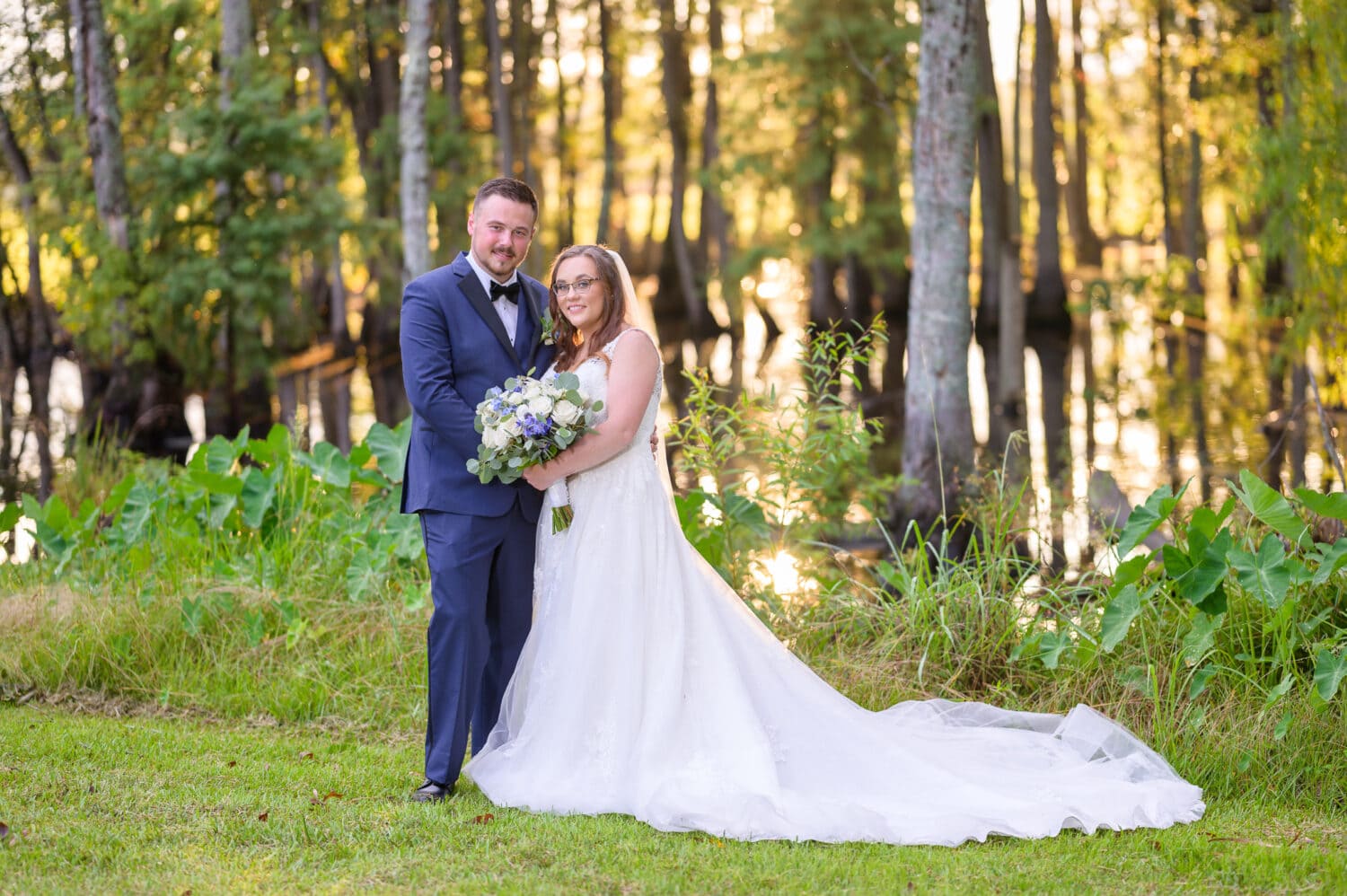 Portrait of bride and groom with sunlight reflection on the marsh - Wildhorse at Parker Farms
