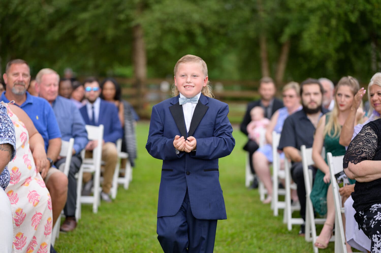 Ring bearer walking the rings down the aisle  - Wildhorse at Parker Farms