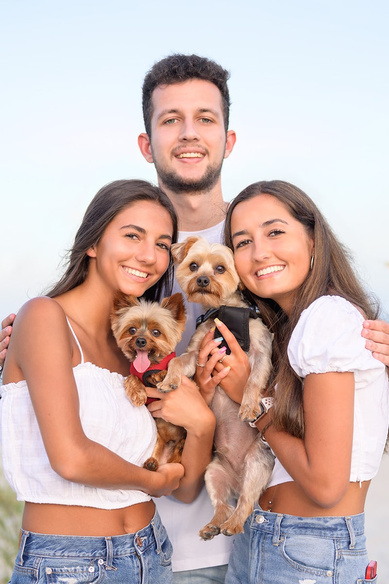 Brother with his two sisters and dogs family pictures on the beach