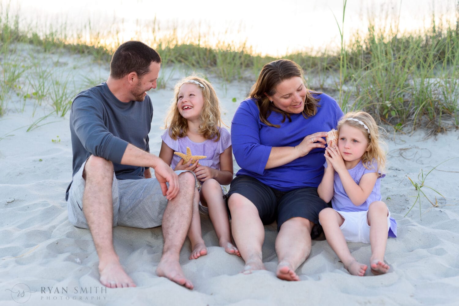 Family of 4 playing with shells by the dunes - Myrtle Beach State Park