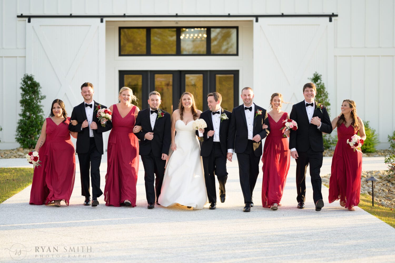 Bride and groom walking with the bridesmaids and groomsmen - The Venue at White Oaks Farm