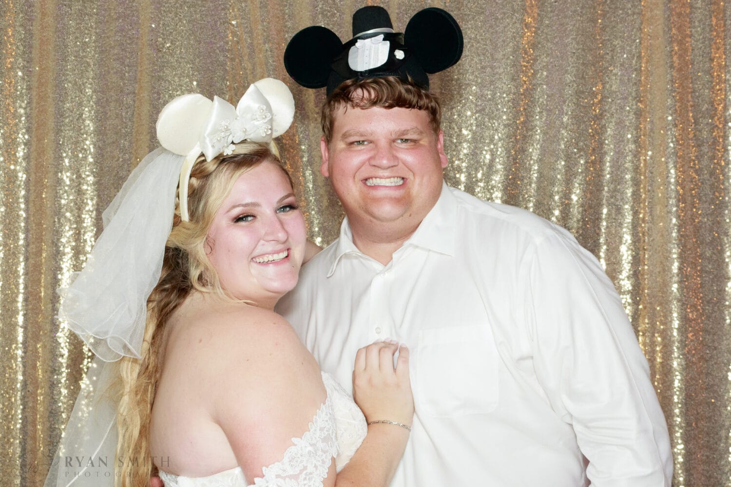 Bride and groom with Disney hats on in Photo Booth -