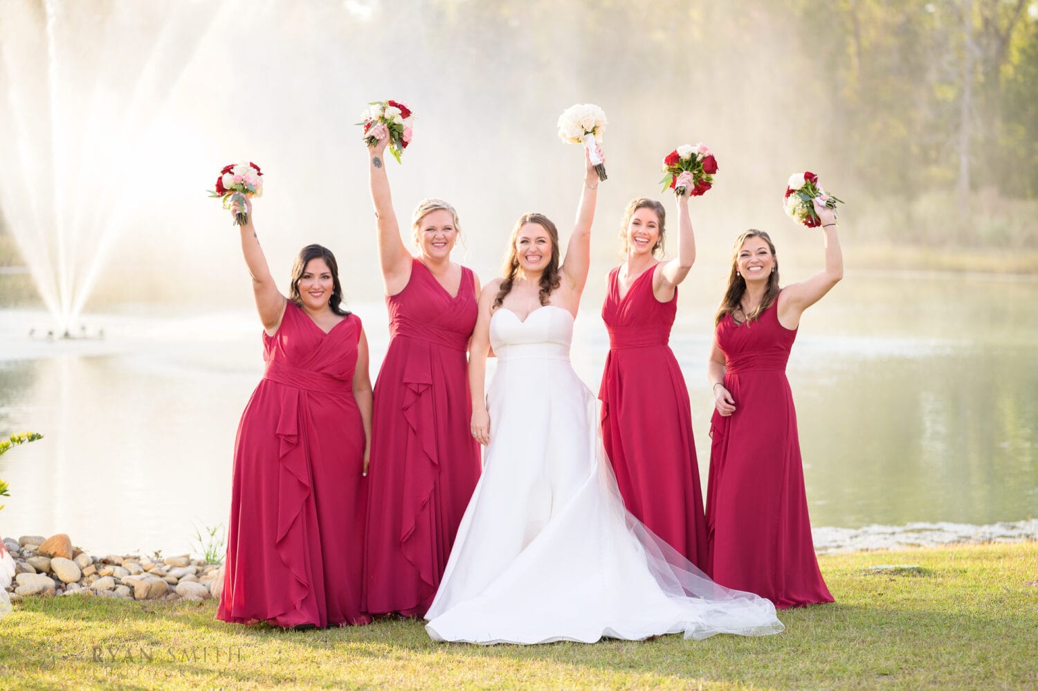 Bridesmaids holding flowers in the air - The Venue at White Oaks Farm