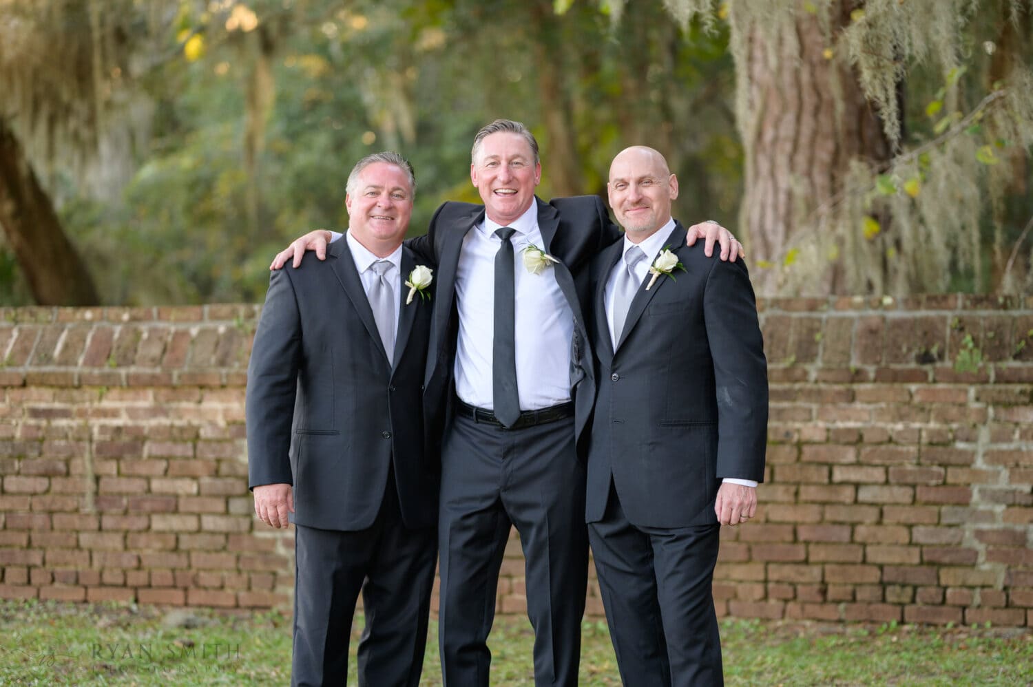 Groom hugging his brothers - Safe Harbor Reserve Harbor Yacht Club