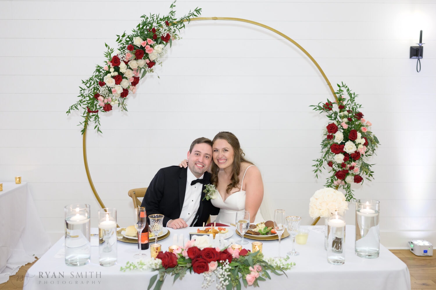 Happy bride and groom at the sweetheart table - The Venue at White Oaks Farm