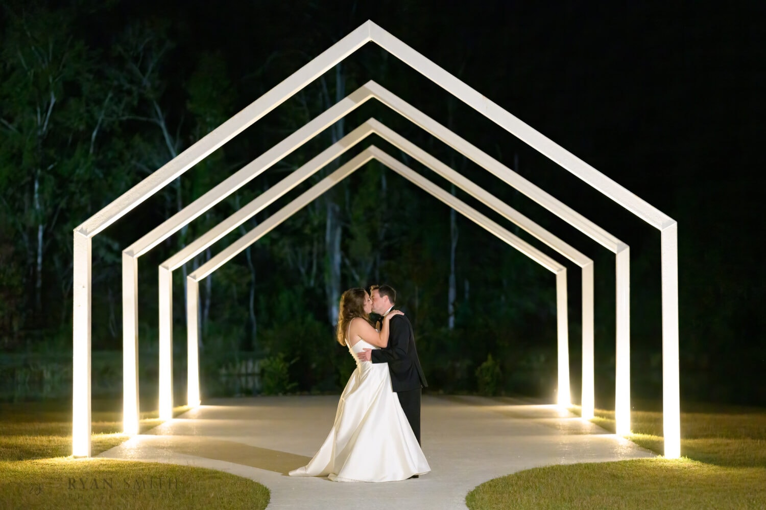 Nighttime under the wedding arches  - The Venue at White Oaks Farm