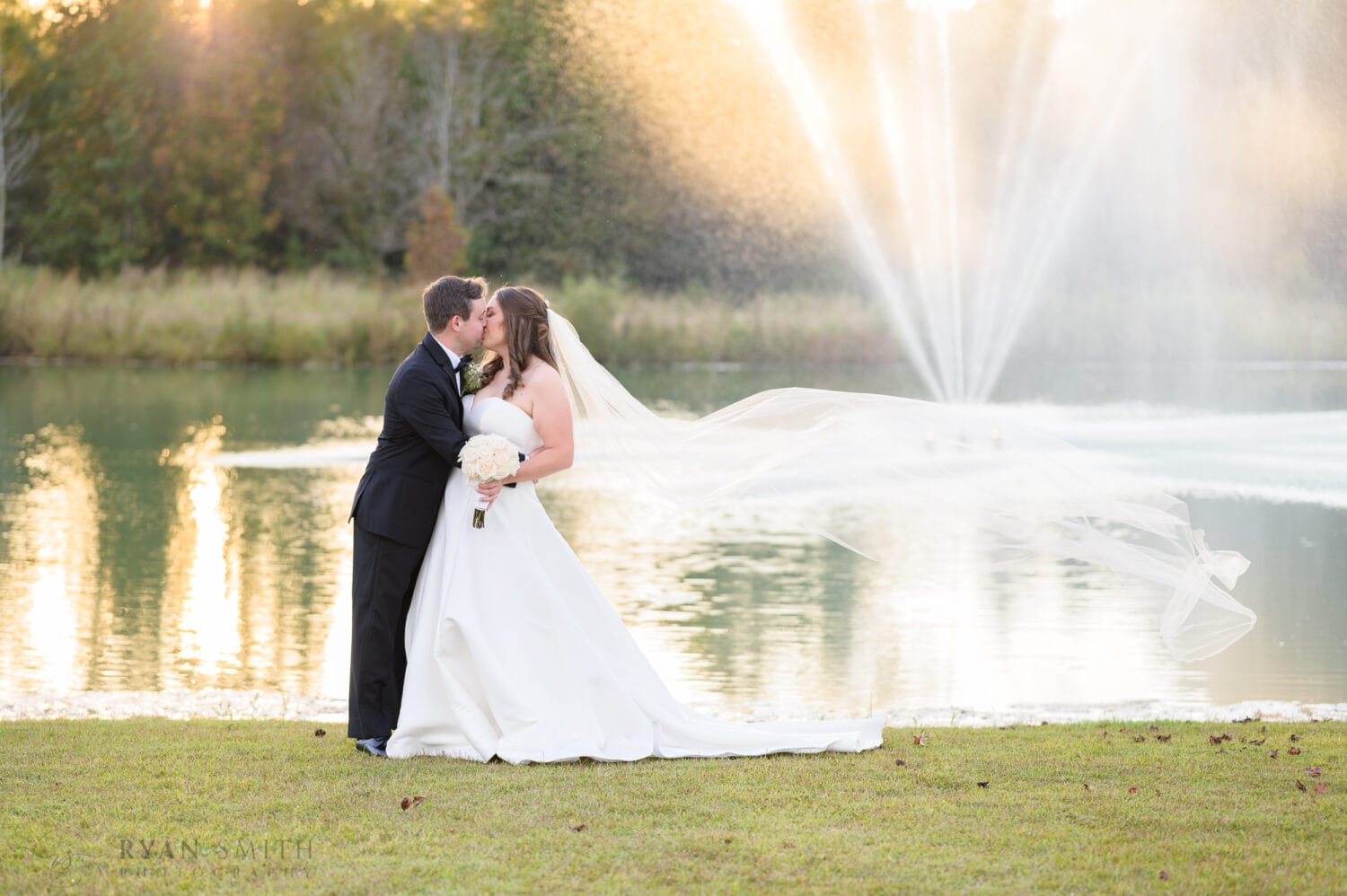 Throwing veil into the air for a kiss - The Venue at White Oaks Farm