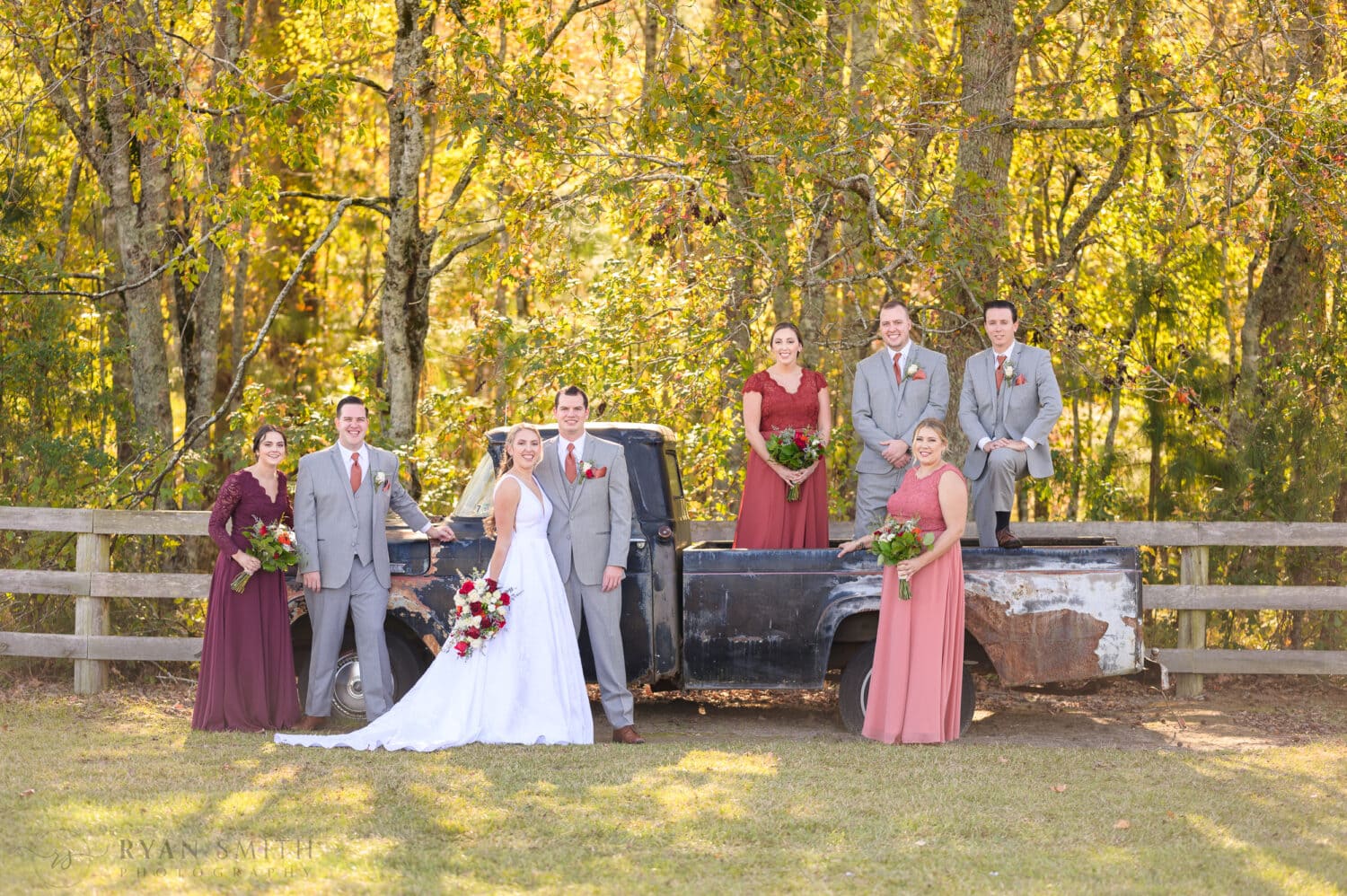 Bridal party with the bride and groom on the old truck - The Blessed Barn