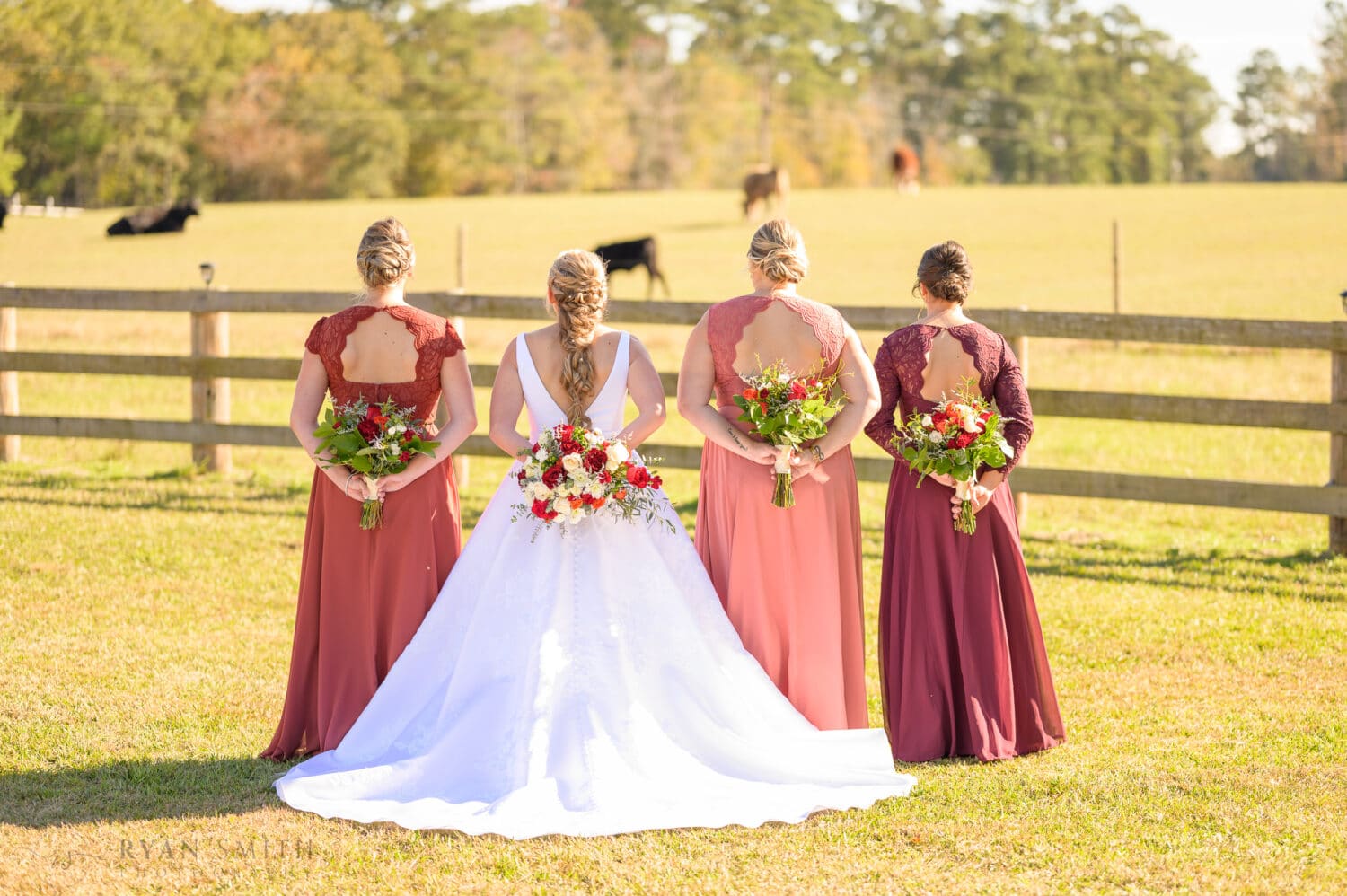 Bridesmaids holding flowers behind their backs - The Blessed Barn