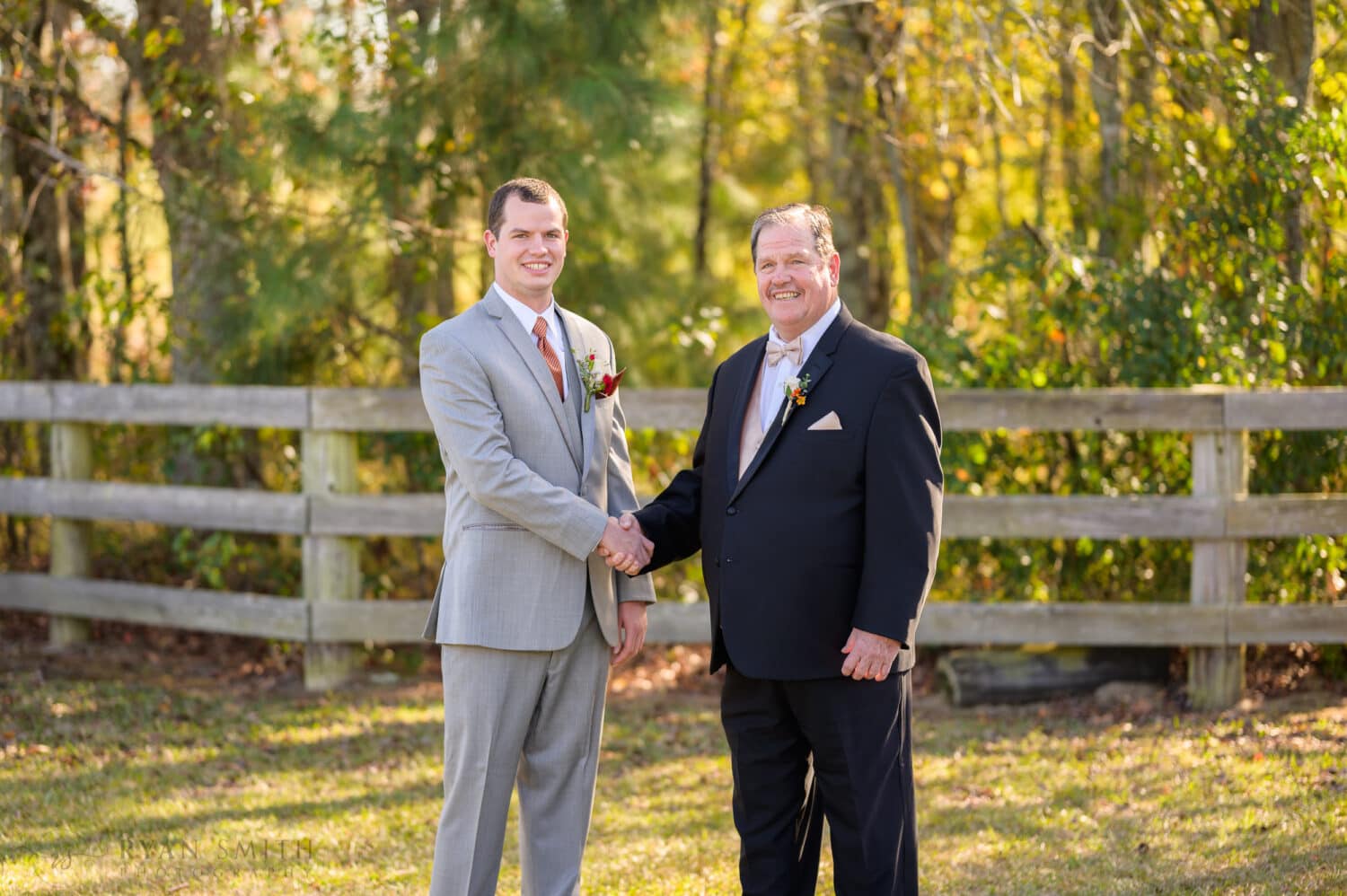 Groom shaking hands with father - The Blessed Barn