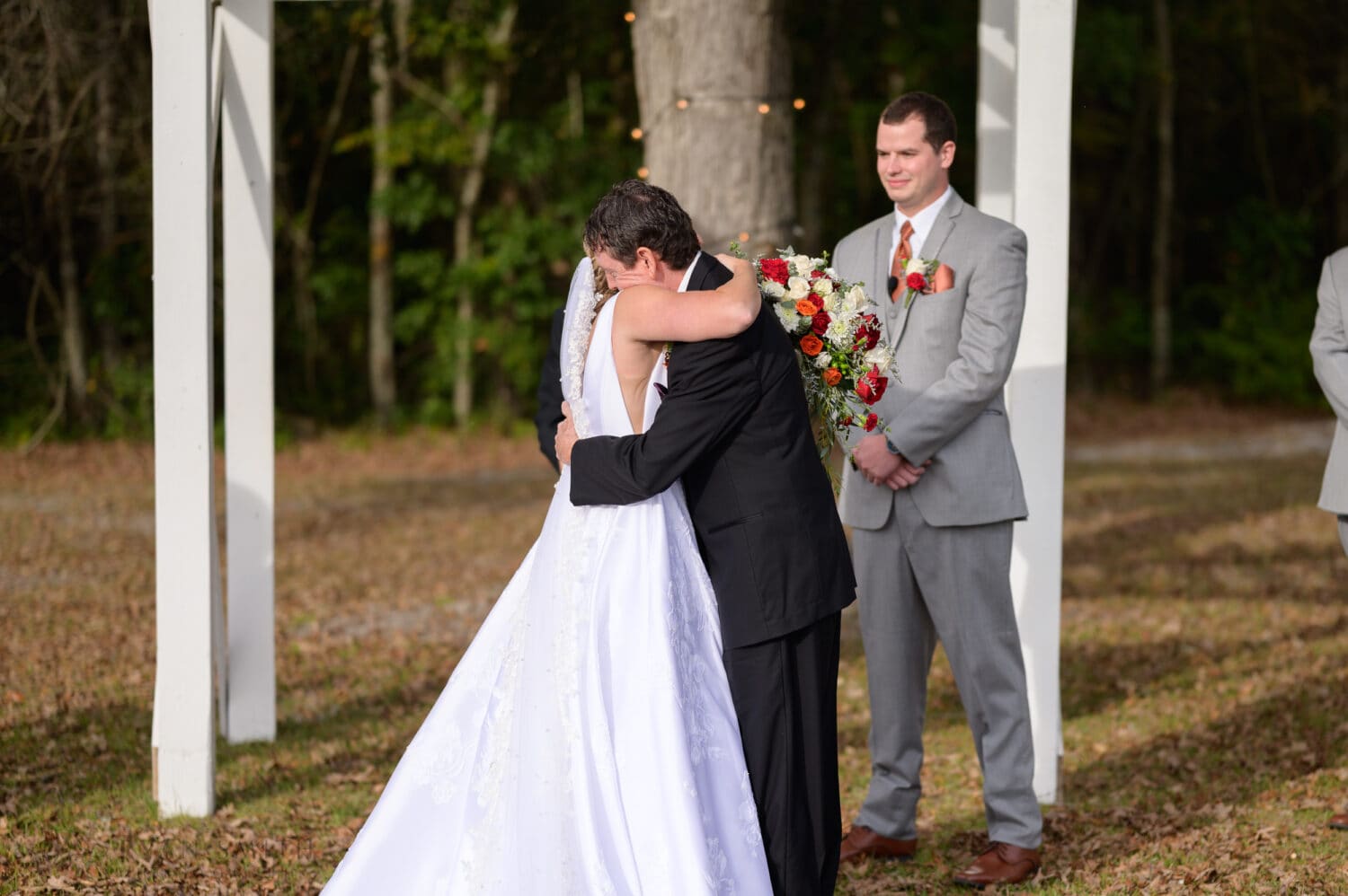 Hug from dad during the ceremony - The Blessed Barn
