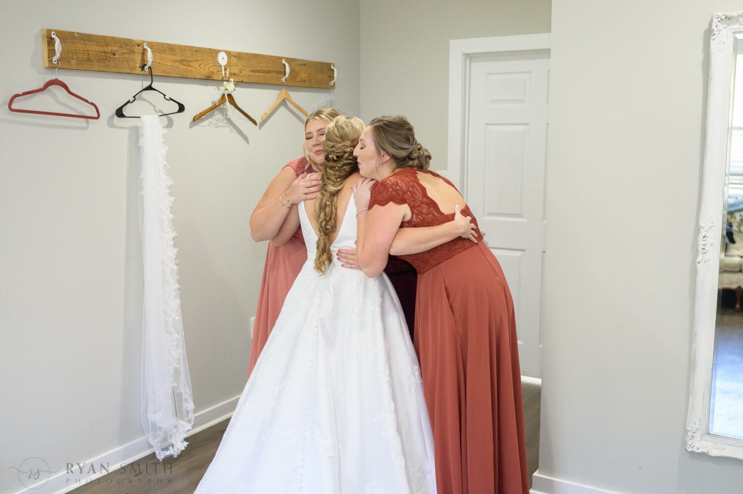 Hug with the bridesmaids - The Blessed Barn