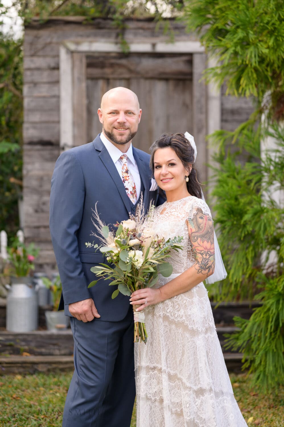 Portraits of the bride and groom in front of the old door - The Cooper House