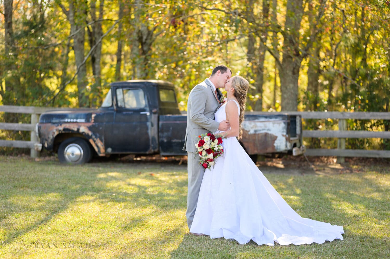 Portraits with the bride and groom in front of the old truck - The Blessed Barn
