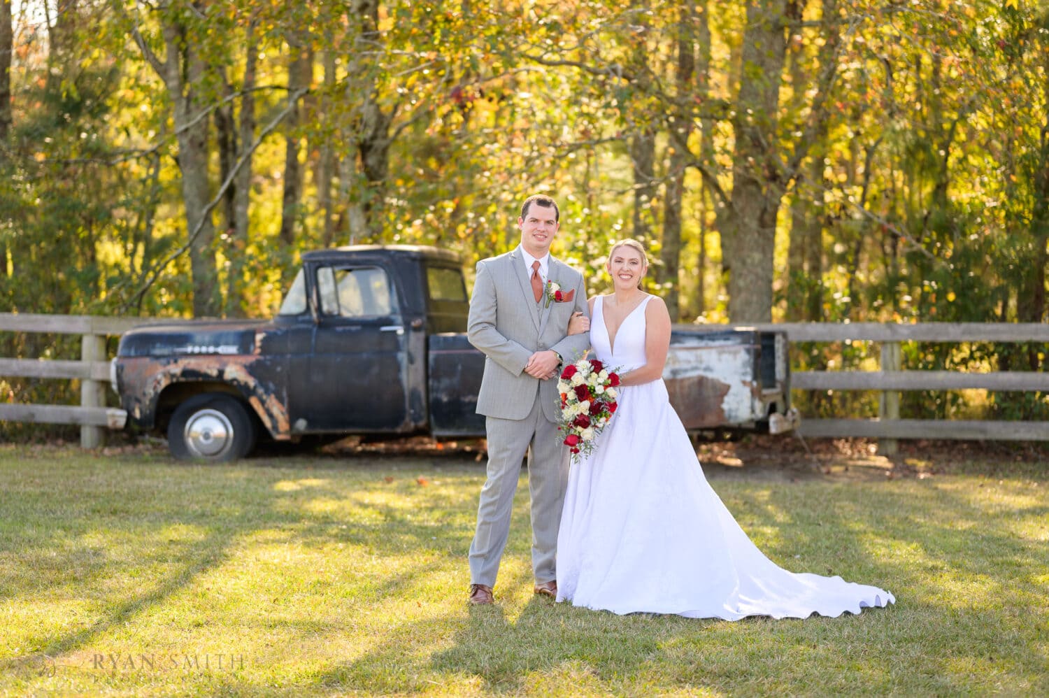 Portraits with the bride and groom in front of the old truck - The Blessed Barn