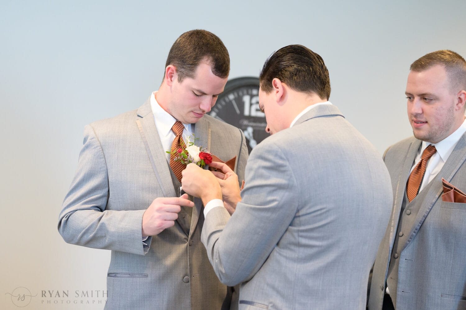 Putting on boutonniere - The Blessed Barn
