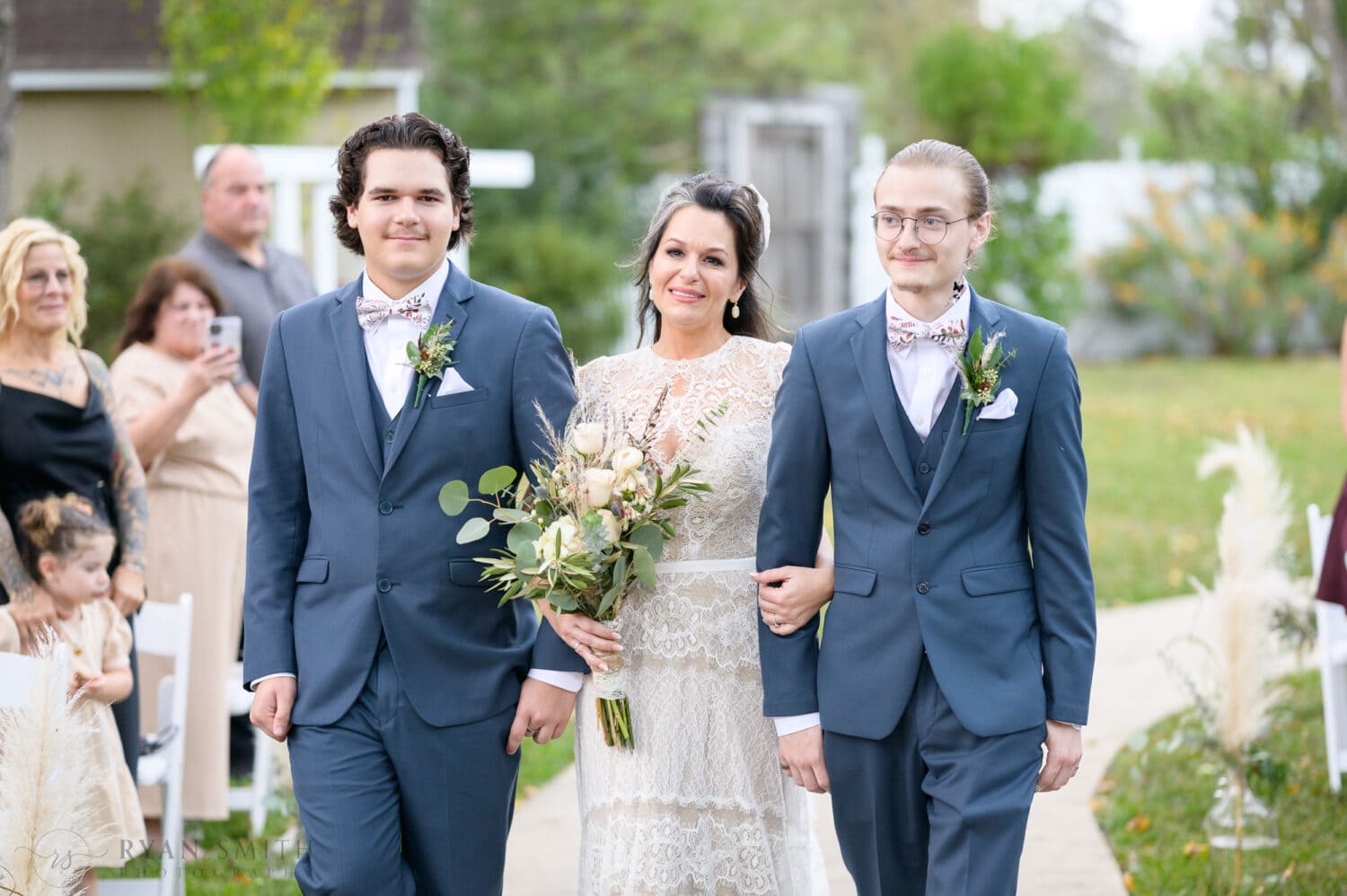Tearful bride walking with sons to the ceremony - The Cooper House