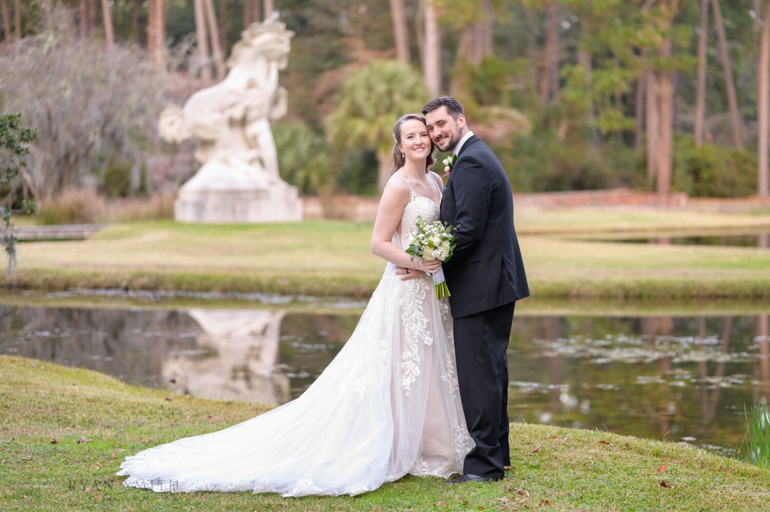 Bride and groom in front of the Youth Taming the Wild Statue - Brookgreen Gardens